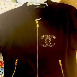 Authentic Chanel small zip up long sleeved with gold stones. New without tags